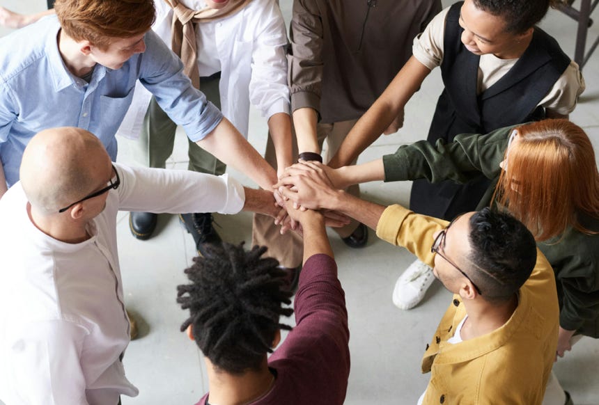 Photo Of People Holding Each Other's Hands